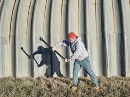 senior athletic male is exercising with a steel mace photo