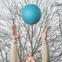 senior man is throwing a heavy slam ball photo