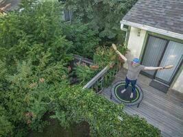 exercising with Indian clubs on a mini trampoline photo