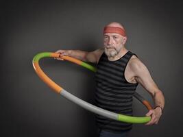 senior man is exercising with a weighted hula hoop photo