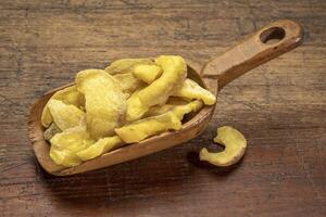 dried guava fruit on a vintage wooden scoop photo