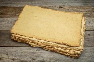 stack of blank handmade paper with rough edges photo