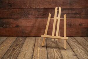 small empty easel against rustic wood photo