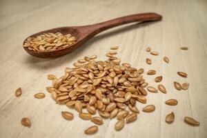 macro shot of golden flax seeds pile photo