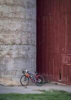 lightweight gravel bike against old barn photo