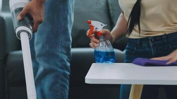 Woman cleaning table using rag and diffuser at home. video