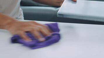 Woman cleaning table using rag and diffuser at home. video