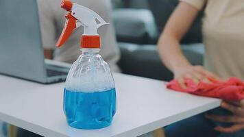 Woman cleaning table using rag and diffuser at home. video