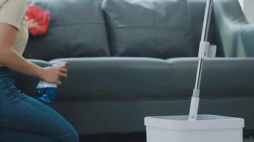 Woman cleaning table using rag and diffuser at home. video