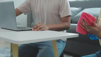 Woman cleaning table using rag and diffuser at home. video