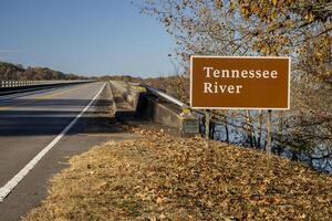 Tennessee River road sign at Natchez Trace Parkway - crossing from Tennessee to Alabama in fall scenery photo