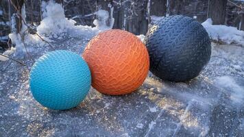 heavy slam balls filled with sand on an icy backyard deck, exercise and functional fitness concept photo