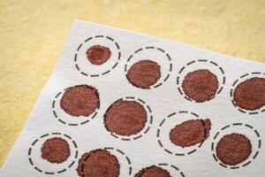 dry blood spots on a fiber filter for laboratory analysis, home health testing concept photo