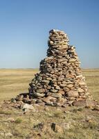 large stone cairn overlooking Colorado prairie photo