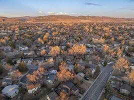 winter morning over a residential street in Fort Collins and Rocky Mountains foothills in northern Colorado, aerial view photo