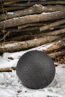 heavy, 50 lb, slam ball filled with sand in a snowy backyard, exercise and functional fitness concept photo