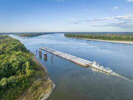 towboat with barges on the Mississippi River is entering Chain of Rocks Bypass Canal above St Louis photo