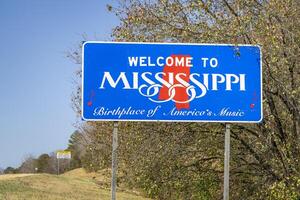 Welcome to Mississippi, Birthplace of America's Music - roadsign at state border with Alabama in late fall scenery photo