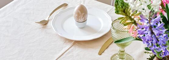 Easter table setting banner with natural Hyacinths flowers. Selective focus, home festive atmosphere photo