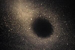 Abstract space background. Galaxy with black hole made of gold paint spray on black background photo