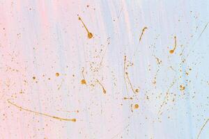 Delicate pink and blue background with gold paint splashes. Place for your design photo