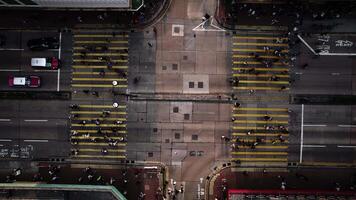 Pedestrian crossing in Hong Kong top view, drone zoom out video