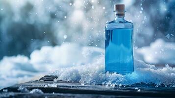 A blue gin bottle ona wooden surface in a snowy background. Generated by artificial intelligence. photo