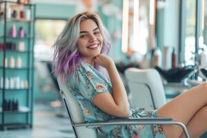 Happy fashionable Caucasian woman with gray and purple color dyed hair sitting in a beauty salon photo