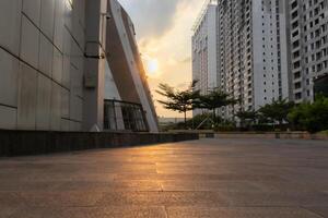 Under exposure. Empty walkway in the city at sunset. After some edits. photo