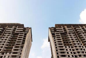 High rise apartment building under construction with blue sky background in the afternoon. After some edits. photo