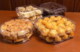 Various dried cakes on wooden table. After some edits. photo