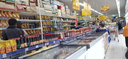 Customer choosing various groceries products in grocery store. Supermarket concept. Bekasi, West Java, Indonesia - March 8 2024 photo