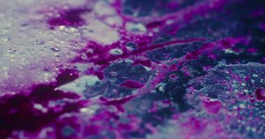 a close up of a purple and black liquid video