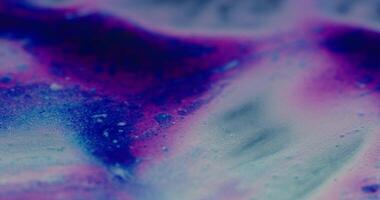 a close up of a blue and purple liquid video