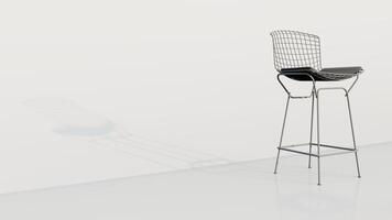 A white chair with a black cushion sits on a white wall photo