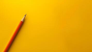 Top view of pencil on yellow background with copy space. photo