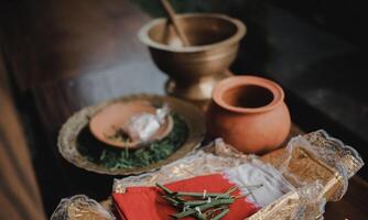 Handmade ceramic craft utensils. Rustic napkins and kitchen utensils. Jug with dried leaves tied on a red cloth. handmade jug. photo