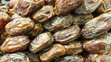 Full Frame Top View of a Stack of Mouthwatering Honey Dried Dates, Dates Arranged on a Table, Dates Background photo