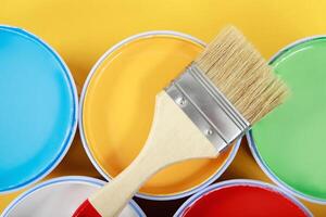 Paint cans and paint brushes and how to choose the perfect interior paint color photo