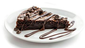 a piece of brownie cake with melted chocolate on a white plate on a white background photo