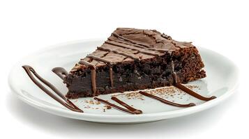 a piece of brownie cake with melted chocolate on a white plate on a white background photo