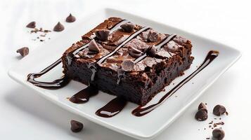 a piece of brownie cake with melted chocolate on a white plate on a white background photo