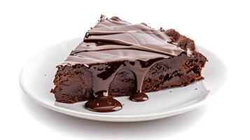 a piece of brownie cake with melted chocolate on a white plate on a white background photo