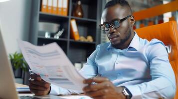 A male businessman is reviewing financial reports photo