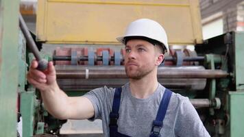 Professional worker closes a valve in an old machine video