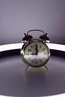 Vertical Stock Photo Of Alarm Bell Clock On Illuminated Nightstand