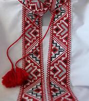 Fragment of Ukrainian black and red ethnic embroidery on the on the collar of a white vyshyvanka shirt photo