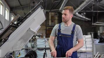 Printing factory unit with an engineer observing the working process video