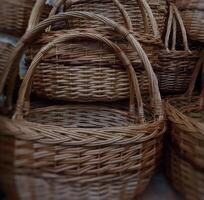 Traditional handicraft of woven baskets with wicker handles photo