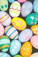 Collection of colorful easter eggs on green grass to celebrate Easter or spring. photo